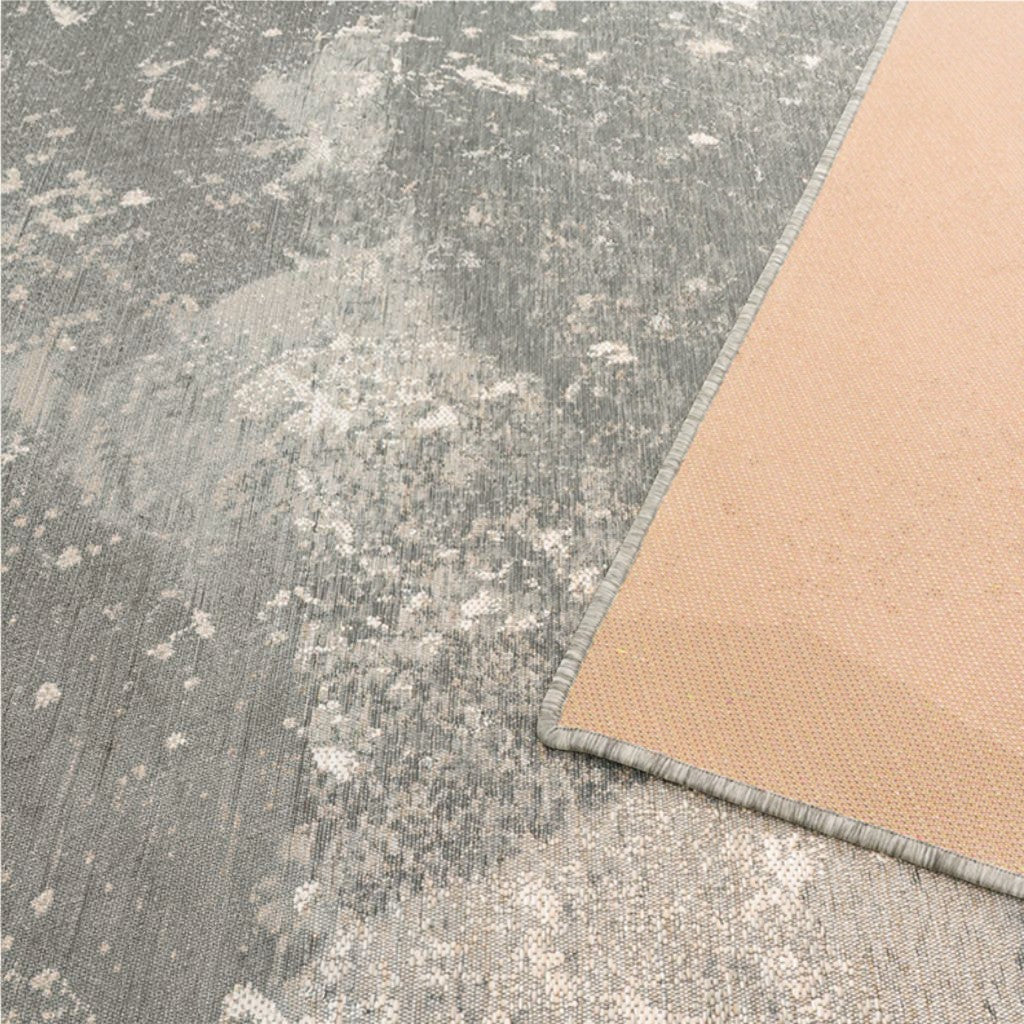HANKI Lichen Stone Rug corner detail showing the durable flat-woven face and non-slip beige backing