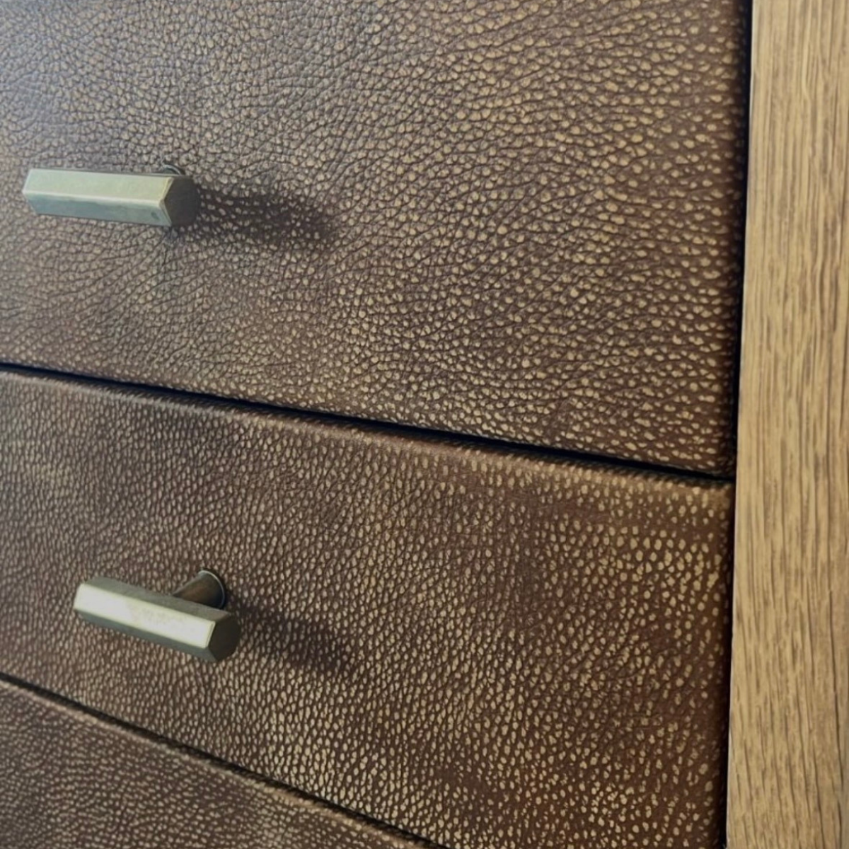 HANKI Reserve wine display leather drawer fronts with brass pull handles close-up